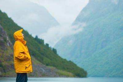 Tourist looking at mountains and fjord Norway, Scandinavia.