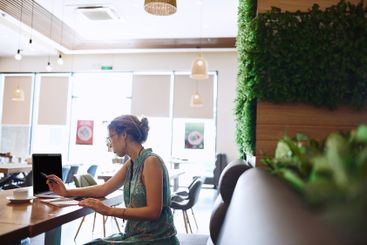 Cafe, businesswoman and laptop with notebook for remote...