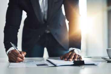 Businessman, writing or documents with contract for...