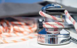 Winch with rope on sailing boat.