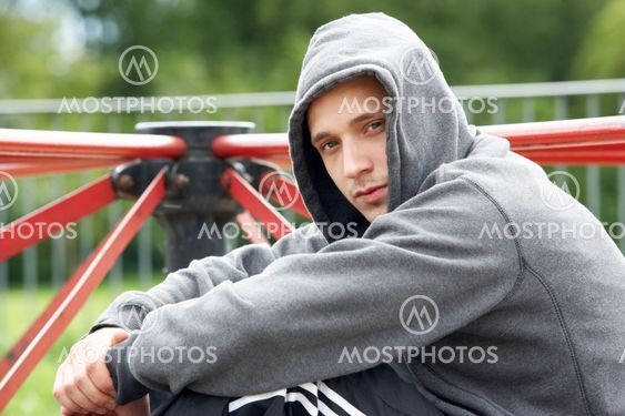 Young Man Sitting In Playground