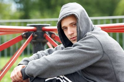 Young Man Sitting In Playground