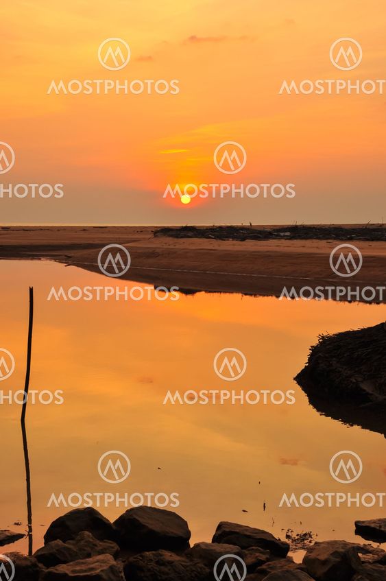 Sunset and stone at the beach