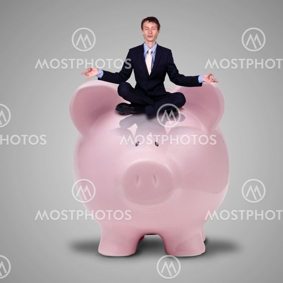 Piggybank and young business man