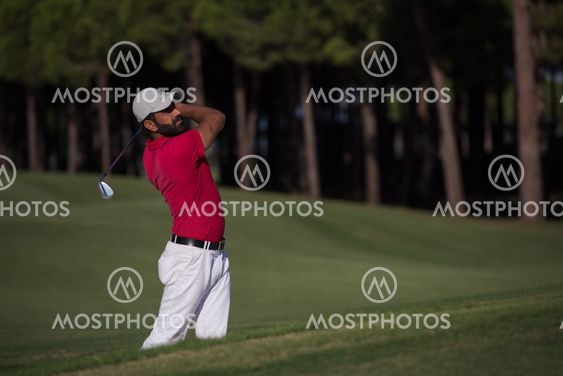 golfer hitting a sand bunker shot