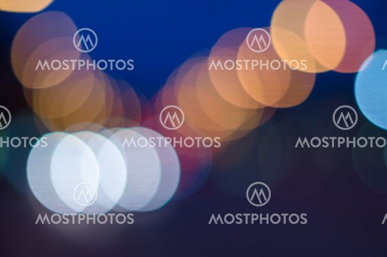 Night city blurred bokeh lights colorful background