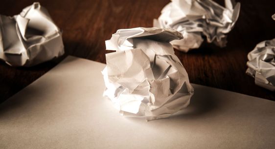 still life of paper and a crumpled paper on a table