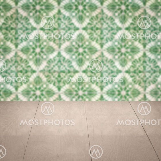 Wood table top and blur vintage ceramic tile pattern wall