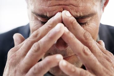 Mature businessman, headache and hands in closeup with...