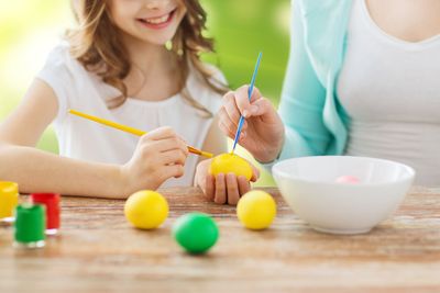 close up of family coloring easter eggs