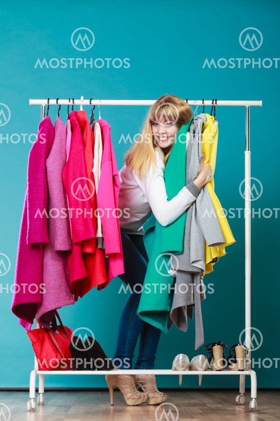 Woman choosing clothes to wear in mall or wardrobe