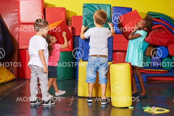 Children helping to tidy up in preschool gym