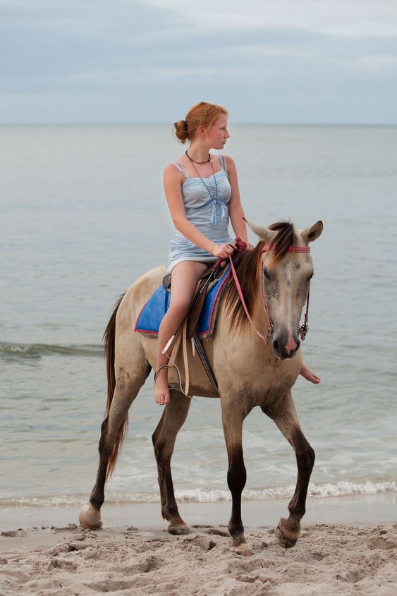 Girl rides on horse