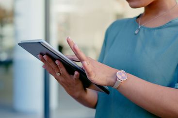 Hands, tablet and a woman closeup in the city for...