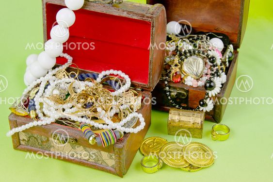 two small boxes with treasures on a light green background