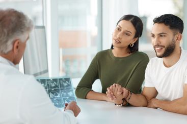 Couple, doctor and scan for consultation in office of...
