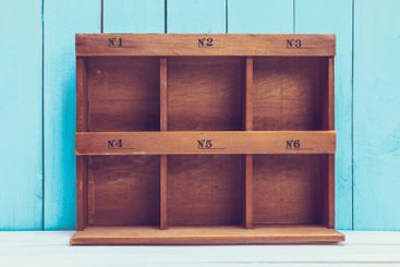 Cozy pastel wooden home decor objects on blue background