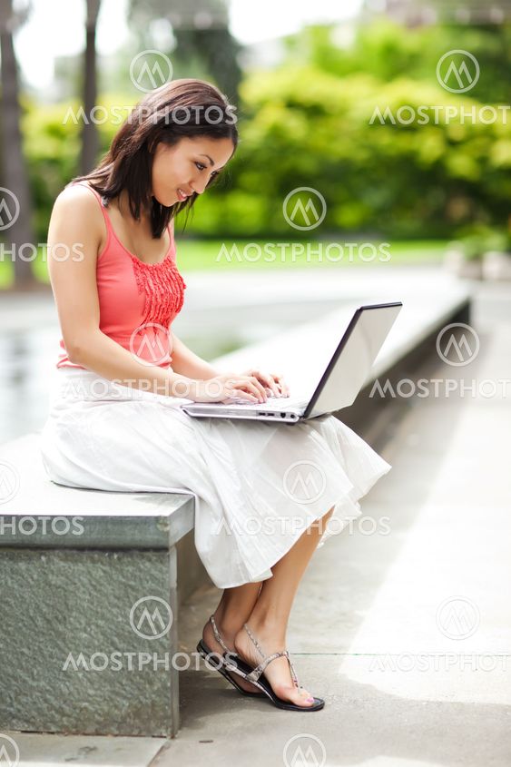 Woman on the phone and working on her laptop