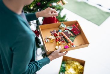 Happy hands Decorating Christmas tree for xmas holiday.