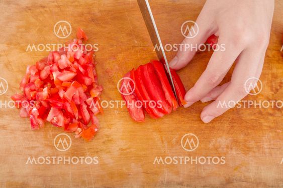 hands cutting tomato
