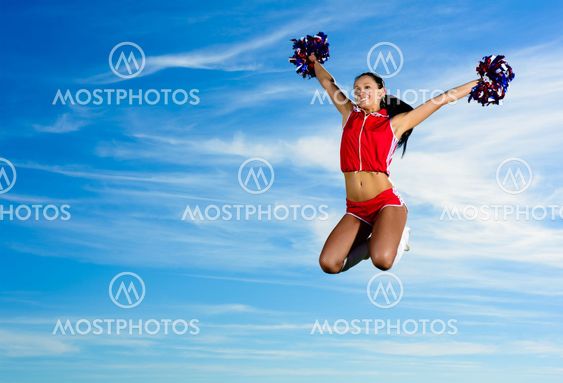 Young cheerleader in red costume jumping