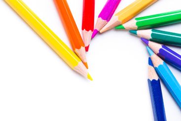 Colorful assortment of colored pencils arranged in a...