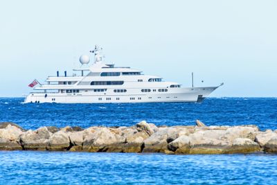 Daylight close-up view to white yacht cruising on water...