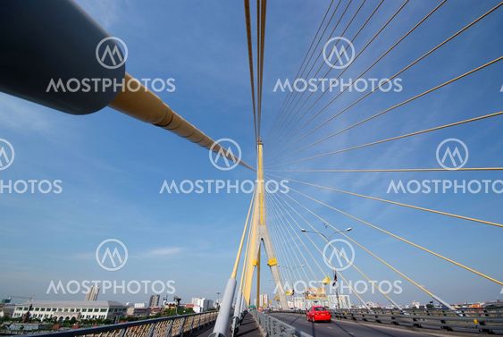 The red car was driving on the bridge.