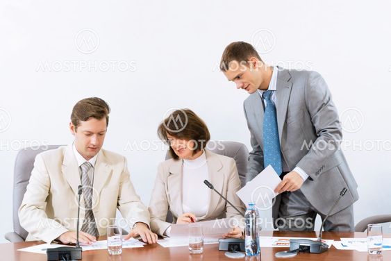 group of business people discussing documents