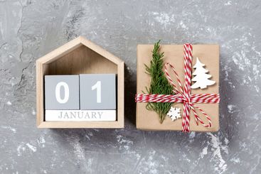 Calendar with date 1 january and gift boxes on color...