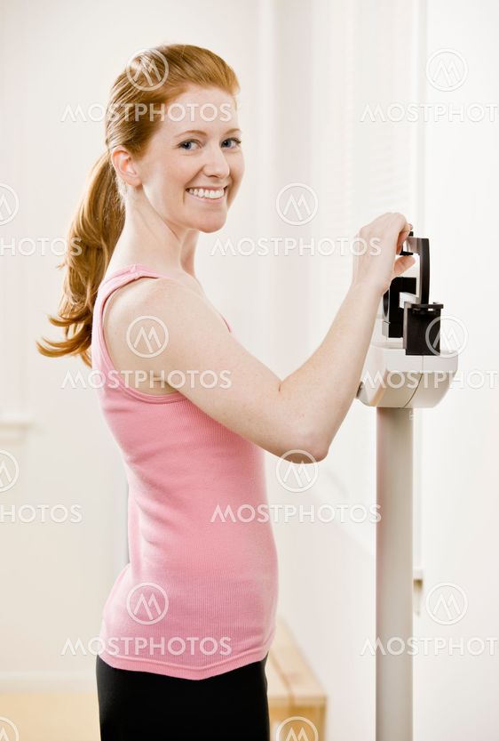 Young Woman Weighing Self