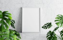 Empty photo frame mockup on white marble table with swiss...