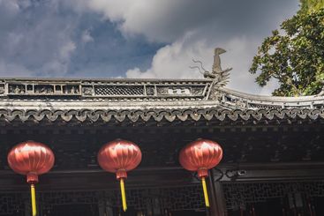 Three bright red Chinese lanterns with yellow tassels 
