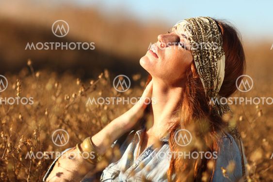 Beautiful Woman on a Field in Summertime