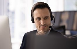Positive thoughtful contact center manager in headset...