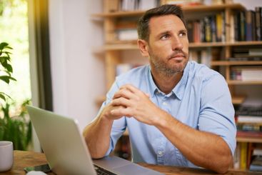 Thinking, computer and man in home office with ideas,...