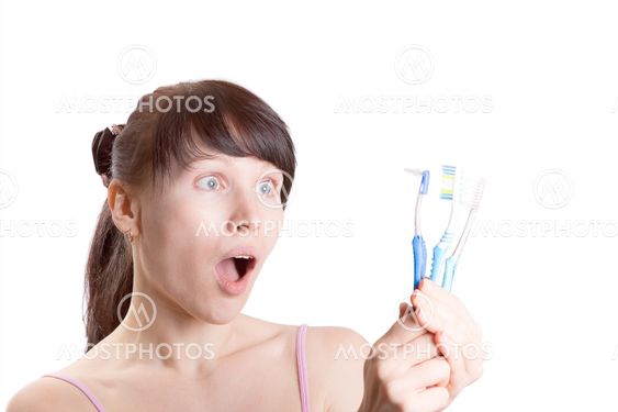 Woman with toothbrushes isolated on white