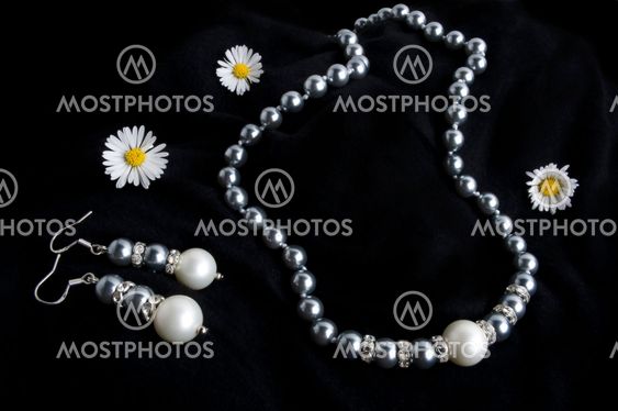Pearls necklace and earrings on black
