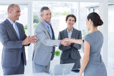 Interview panel shaking hands with applicant