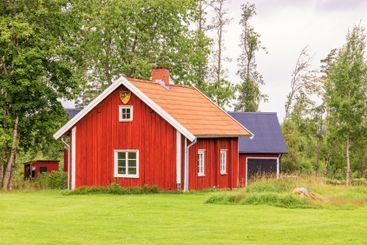Red wooden cottage in the Swedish countryside