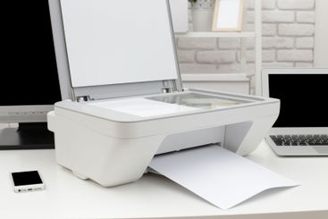 Home office setup with a printer scanning documents...