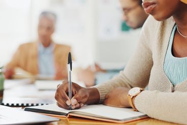 Book, hands or business woman writing in office with...