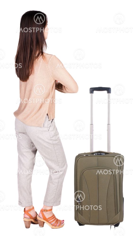 back view of standing young beautiful brunette woman.