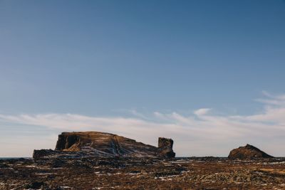 beautiful scenic view of rocks with snow and seacoast in...