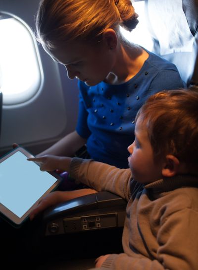 Mother traveling on a plane with her small son