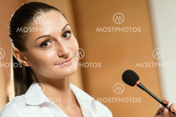Portrait of a business woman with microphone
