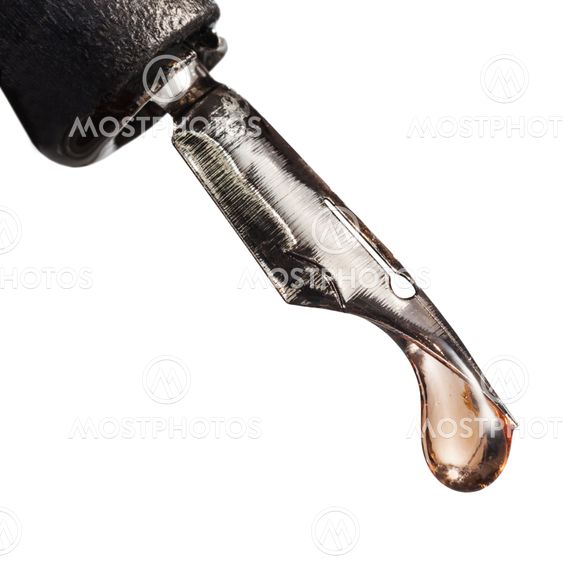 macro view of drop liquid on tip of pen