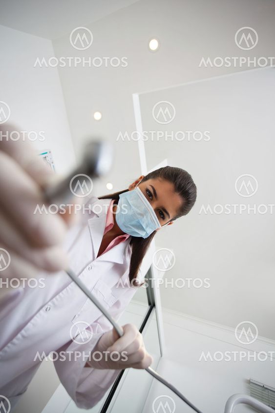 Female dentist holding drill