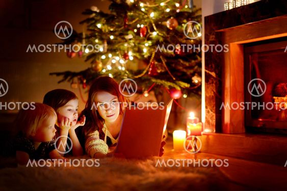 Mother and her daughters reading a book