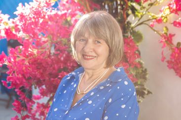 Portrait of an elderly woman in a blue festive dress on...